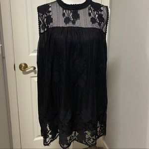 Lacy black swingy top fits a fringe hemline.